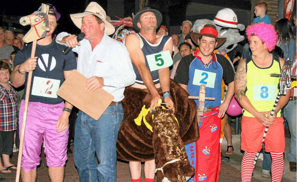 Celebrity horse race entrants line up with race caller Mal Sheard.